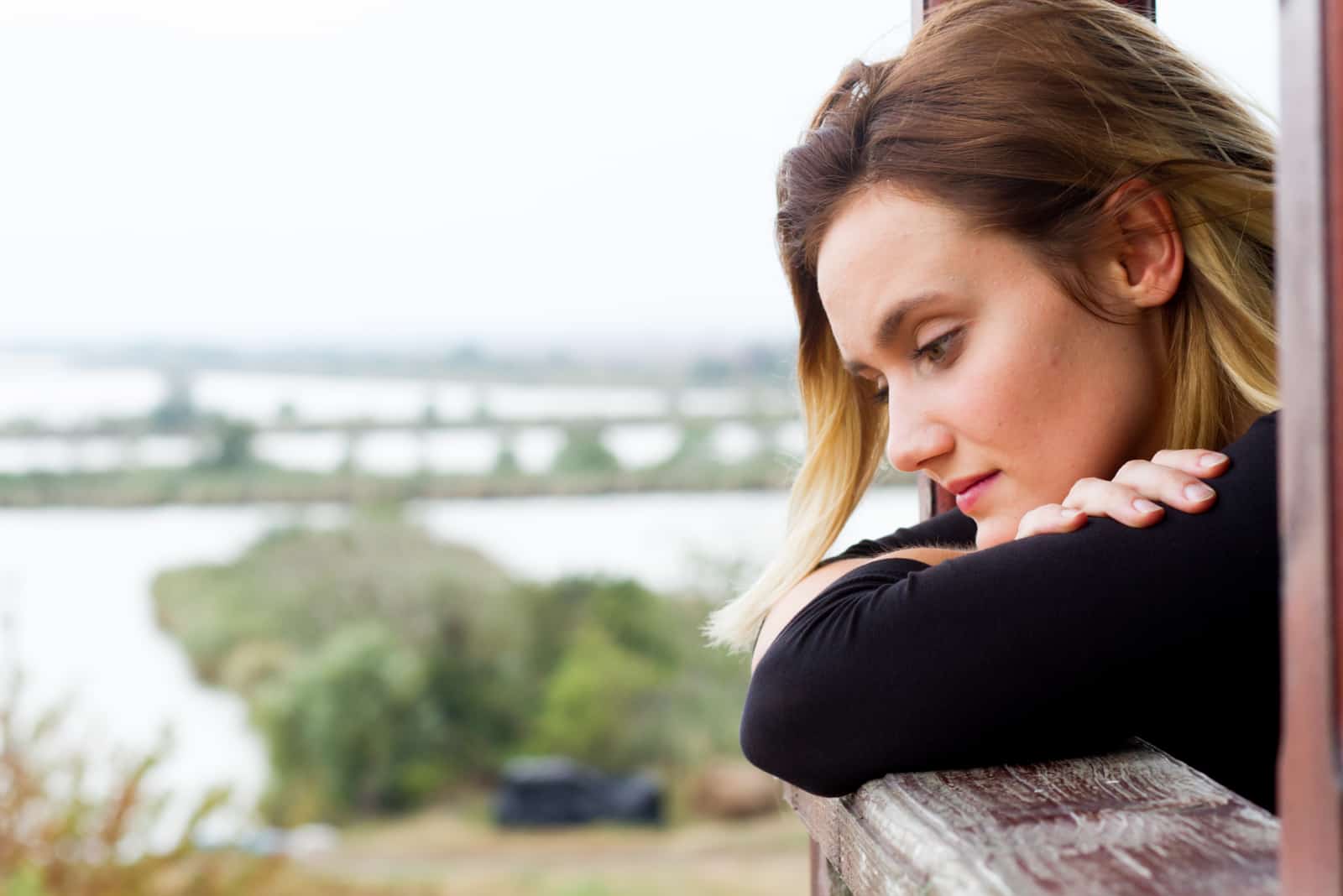 an imaginary woman leaning against a fence