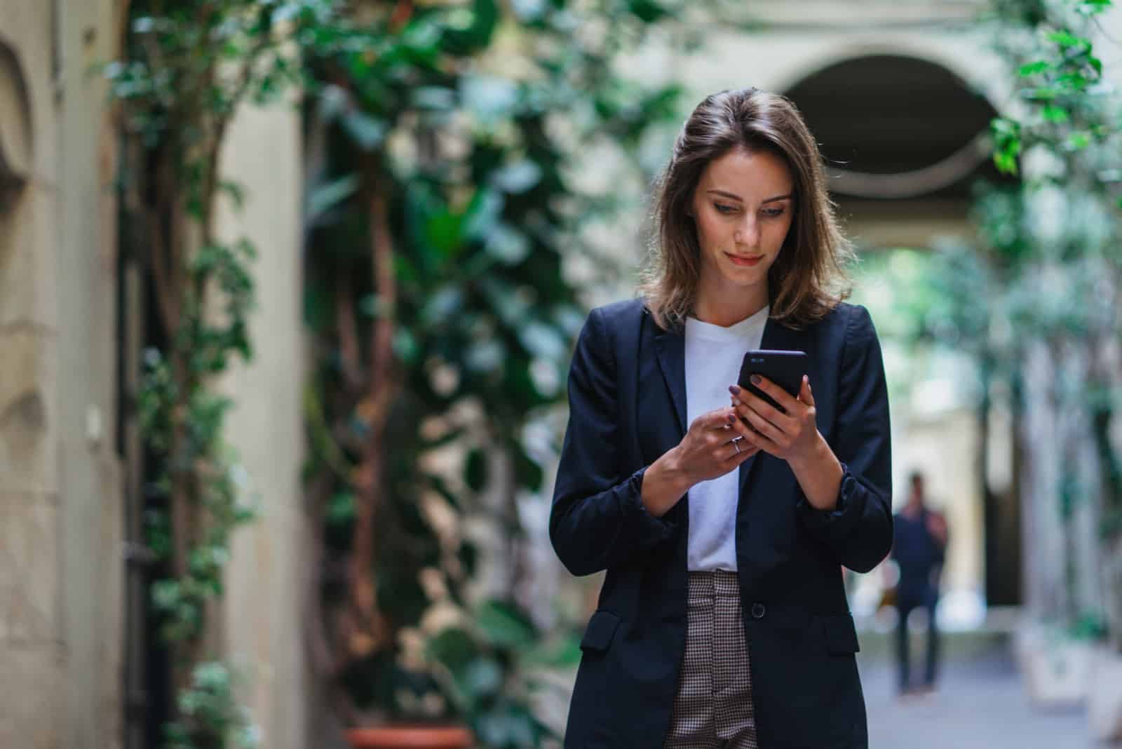 an imaginary woman standing on the street holding a phone in her hand