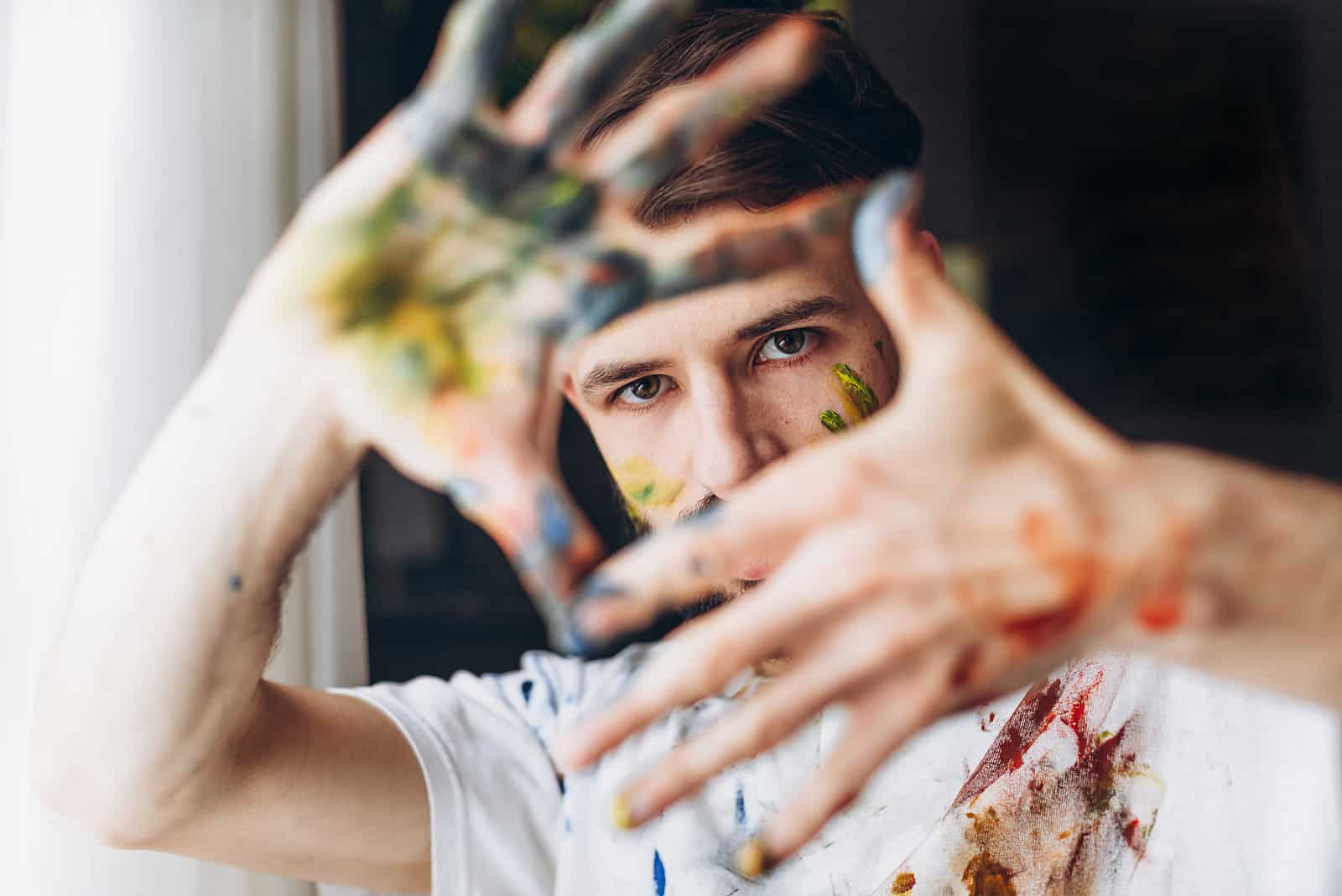 artista con le mani sporche di vernice