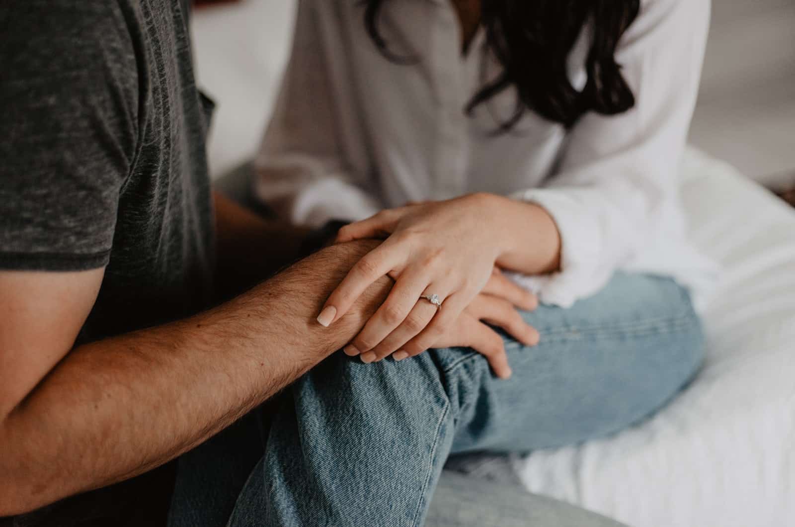 couple holding hands while talking