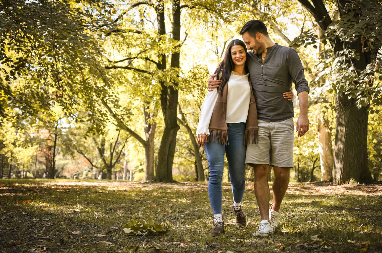 couple walking outside in park