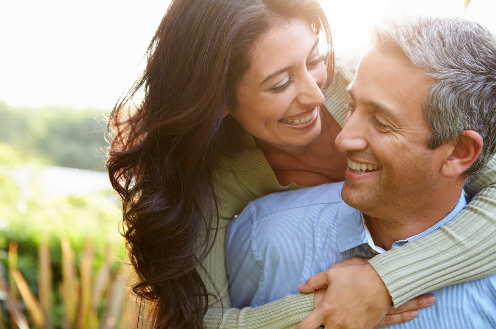 happy couple hugging outside