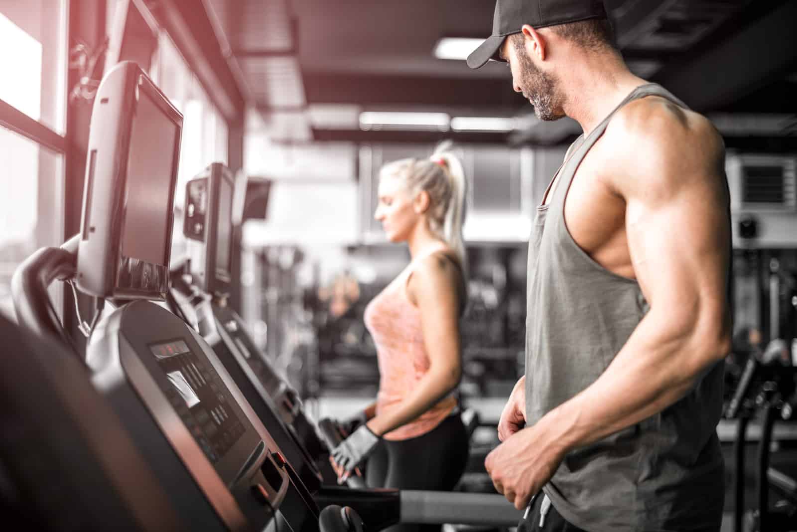 man looking at woman on treadmill