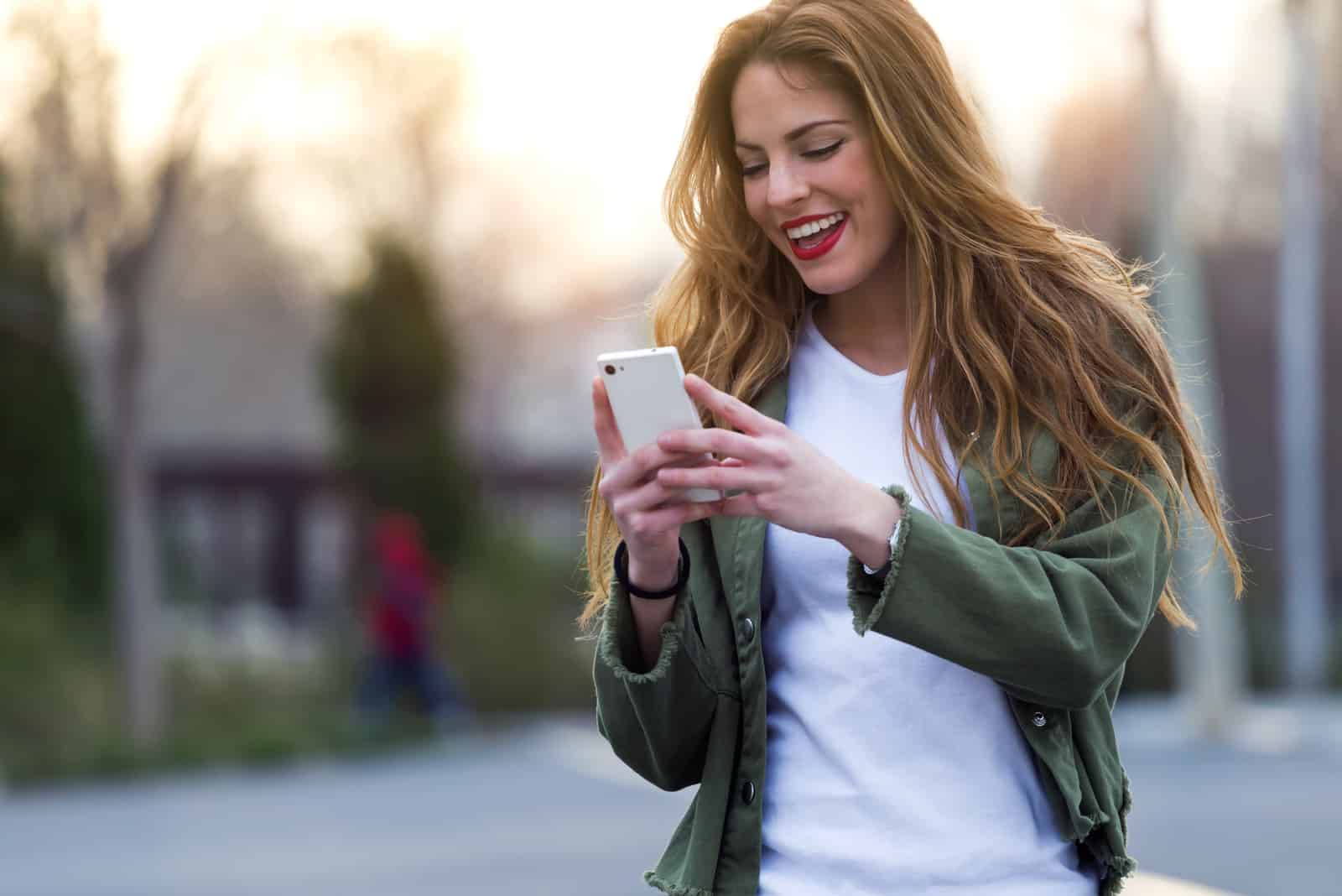 smiling woman with long brown hair button on the phone
