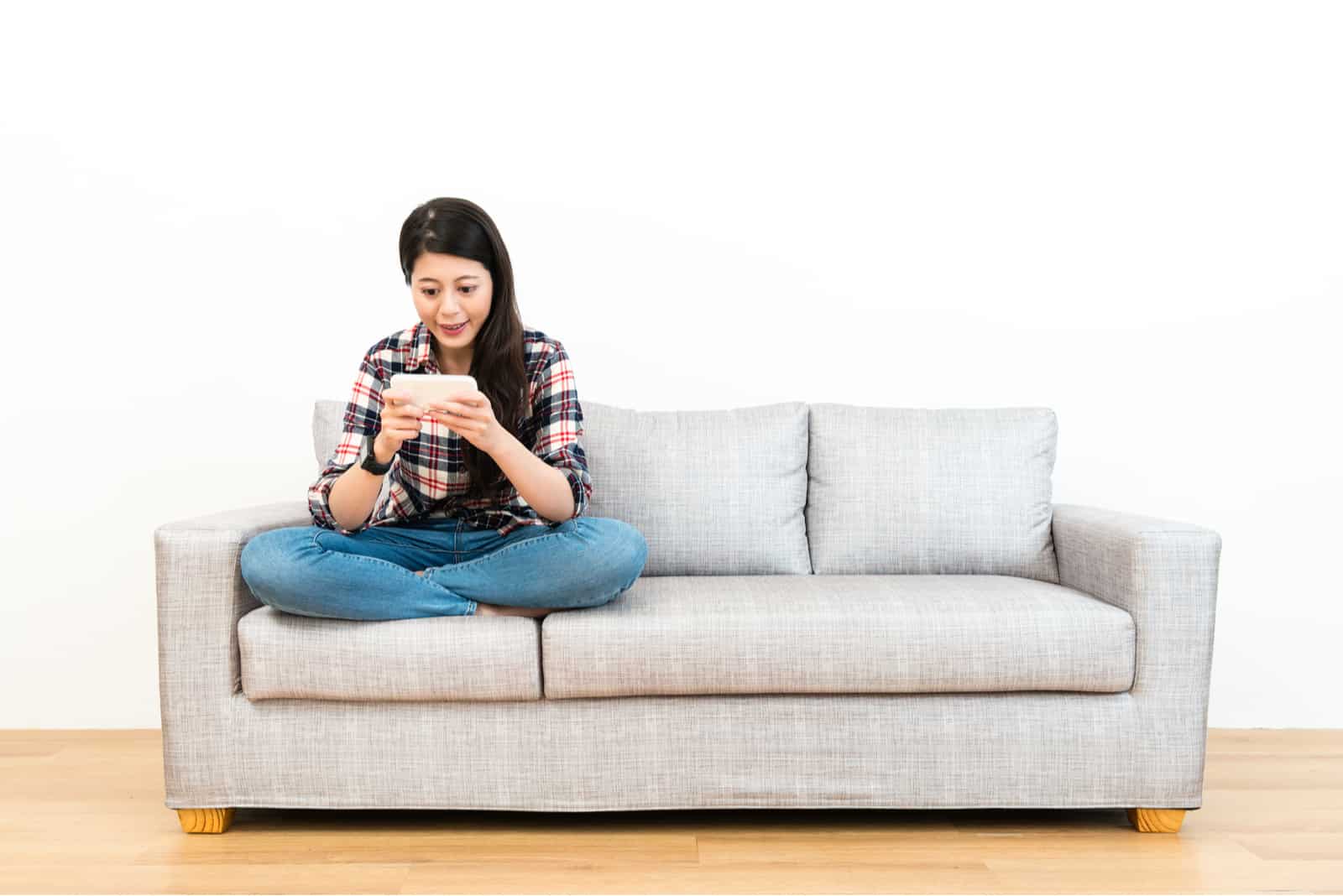 woman sitting on a gray sofa