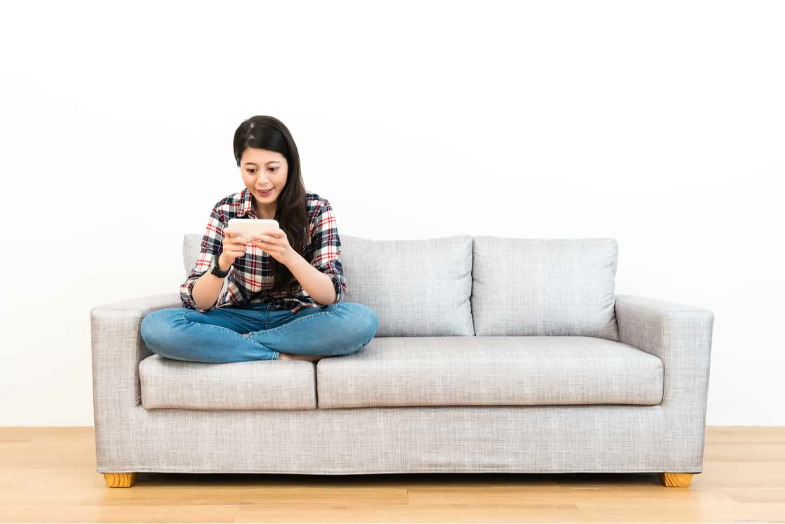woman sitting on a gray sofa