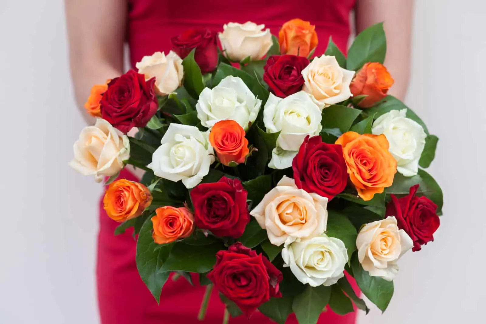 women holding colorful rose bouquet