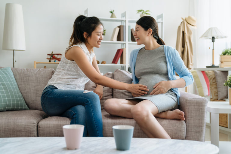 pregnant woman talking to friend