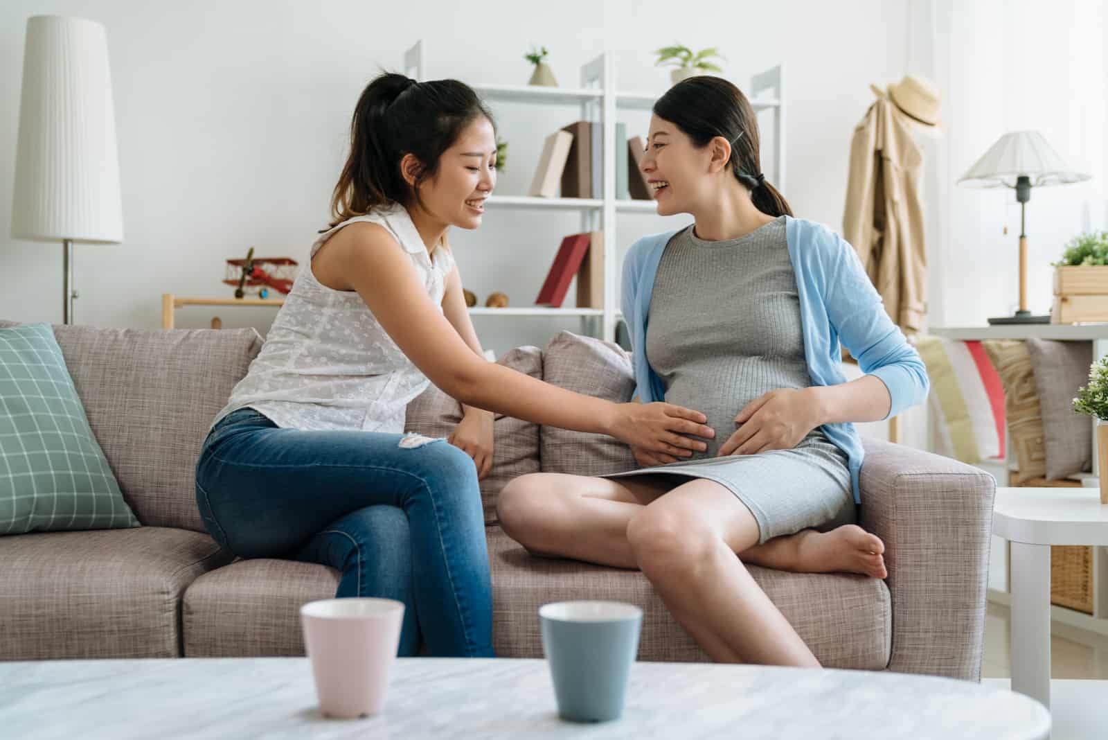 pregnant woman talking to friend
