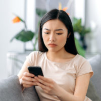 worried woman looking at texts