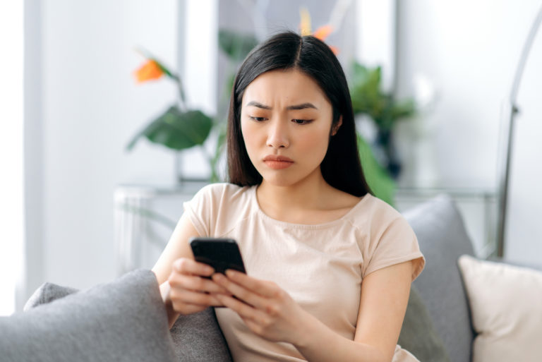 worried woman looking at texts