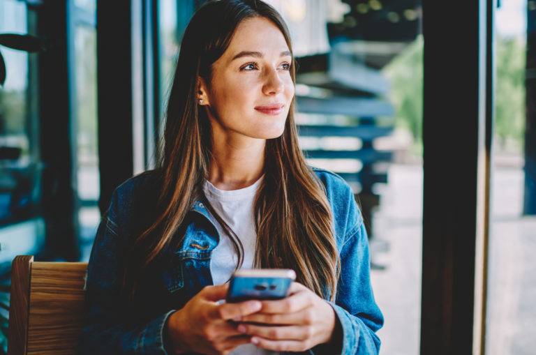 woman typing on phone