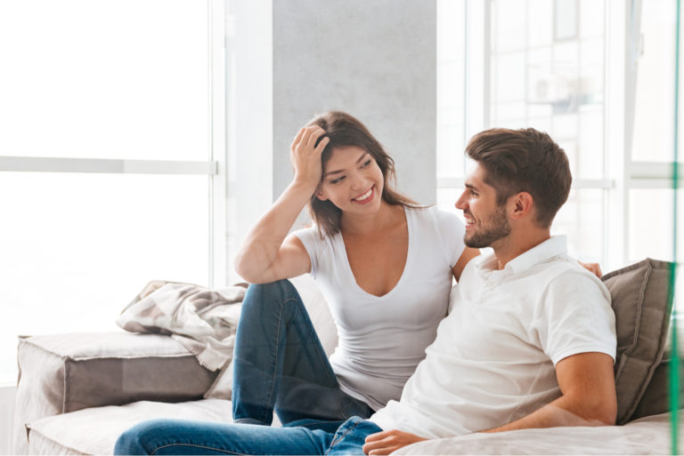 young couple talking on the couch