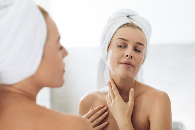woman checking her reflection in the mirror