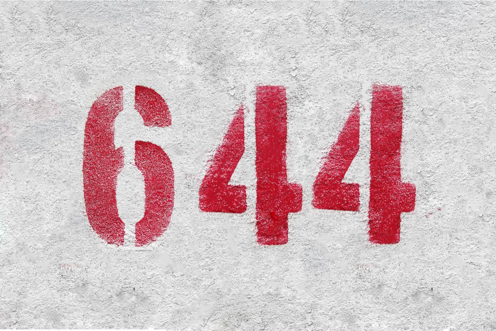 red number 644 on grey wall