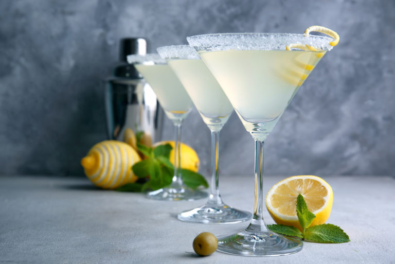 margaritas in glasses with lemons on the table