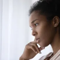young woman in deep thoughts looking away