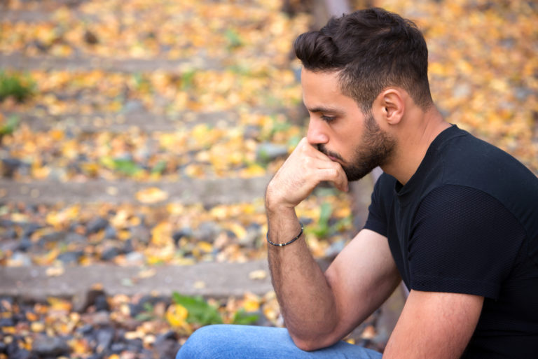 sad man sitting alone and thinking