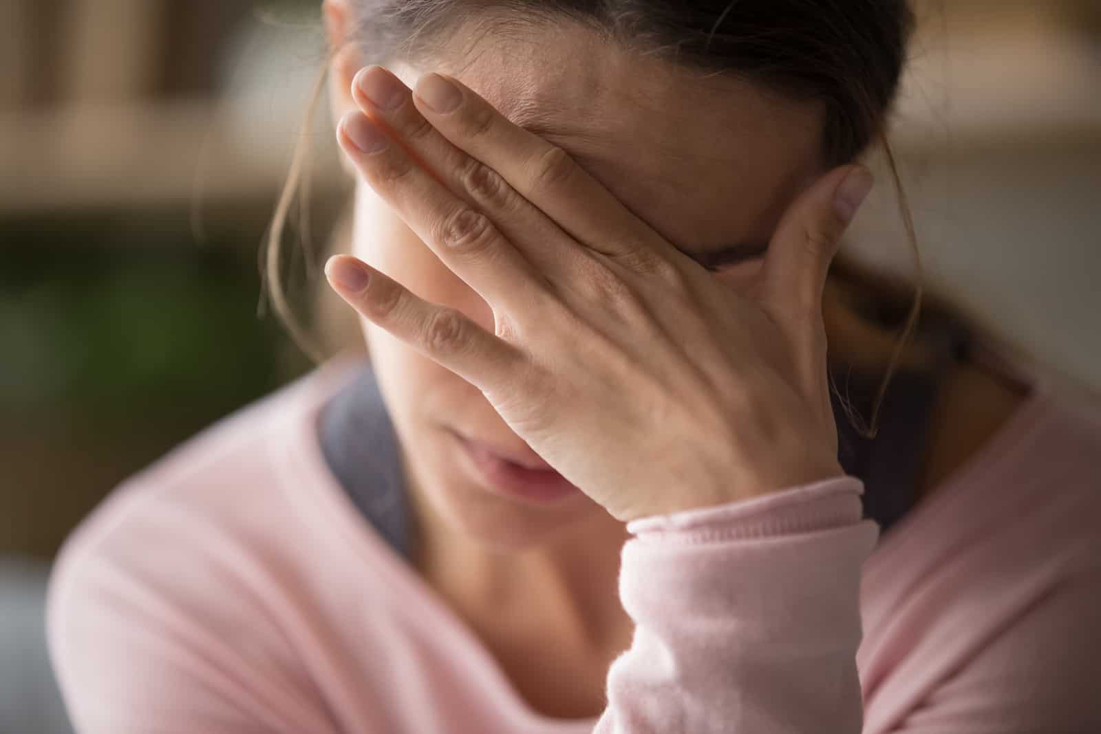 woman covering her head with her hands