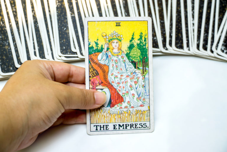 man holding tarot card