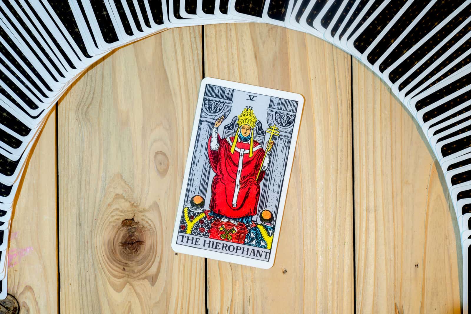 The Hierophant Reversed tarot card on table