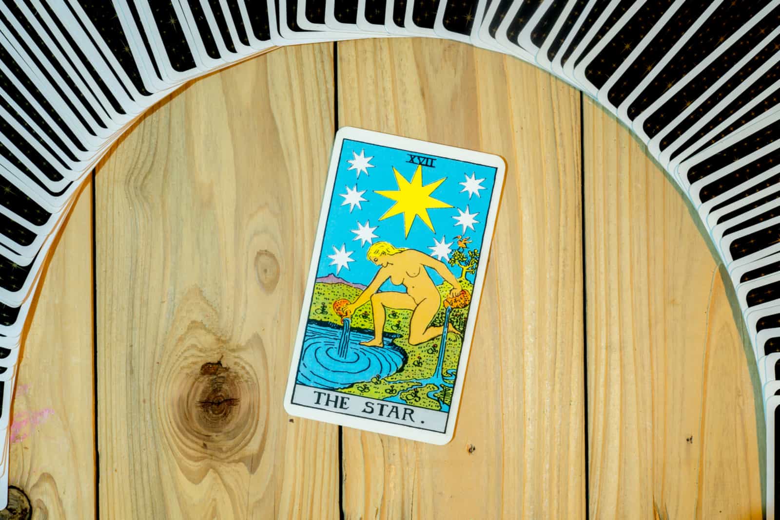 The Star Tarot card on table