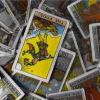 The Fool Reversed on pile of Tarot Cards