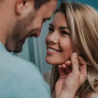 man carresing woman's face