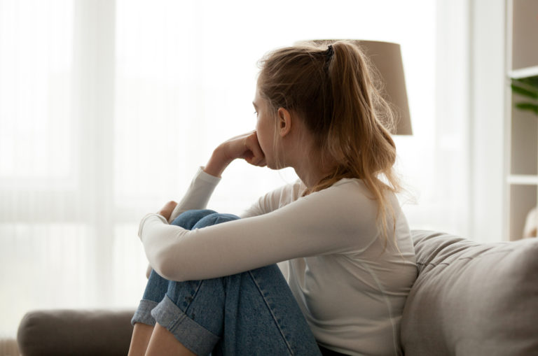 sad woman sitting on sofa