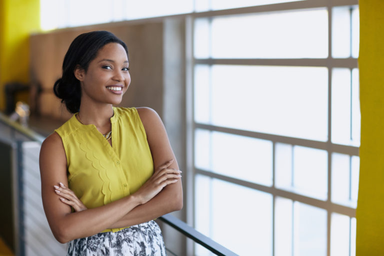 smiling woman posing with crossed arms