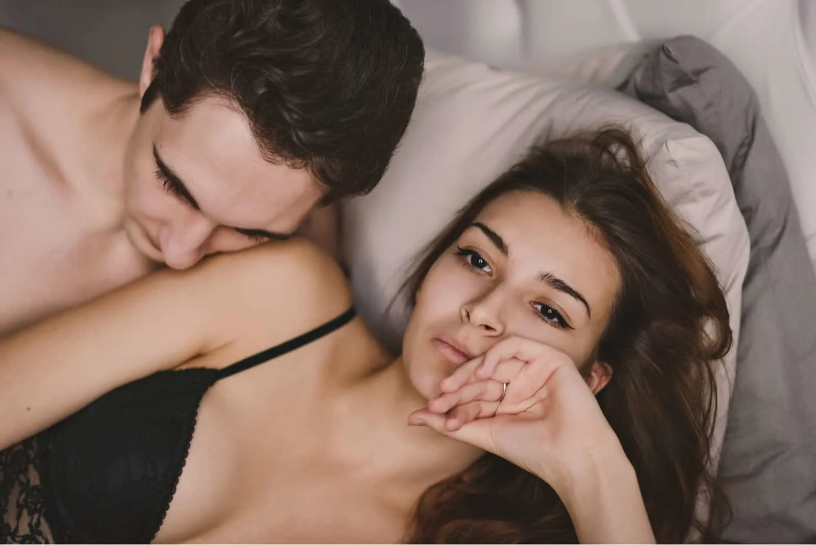 disinterested woman in bed with man