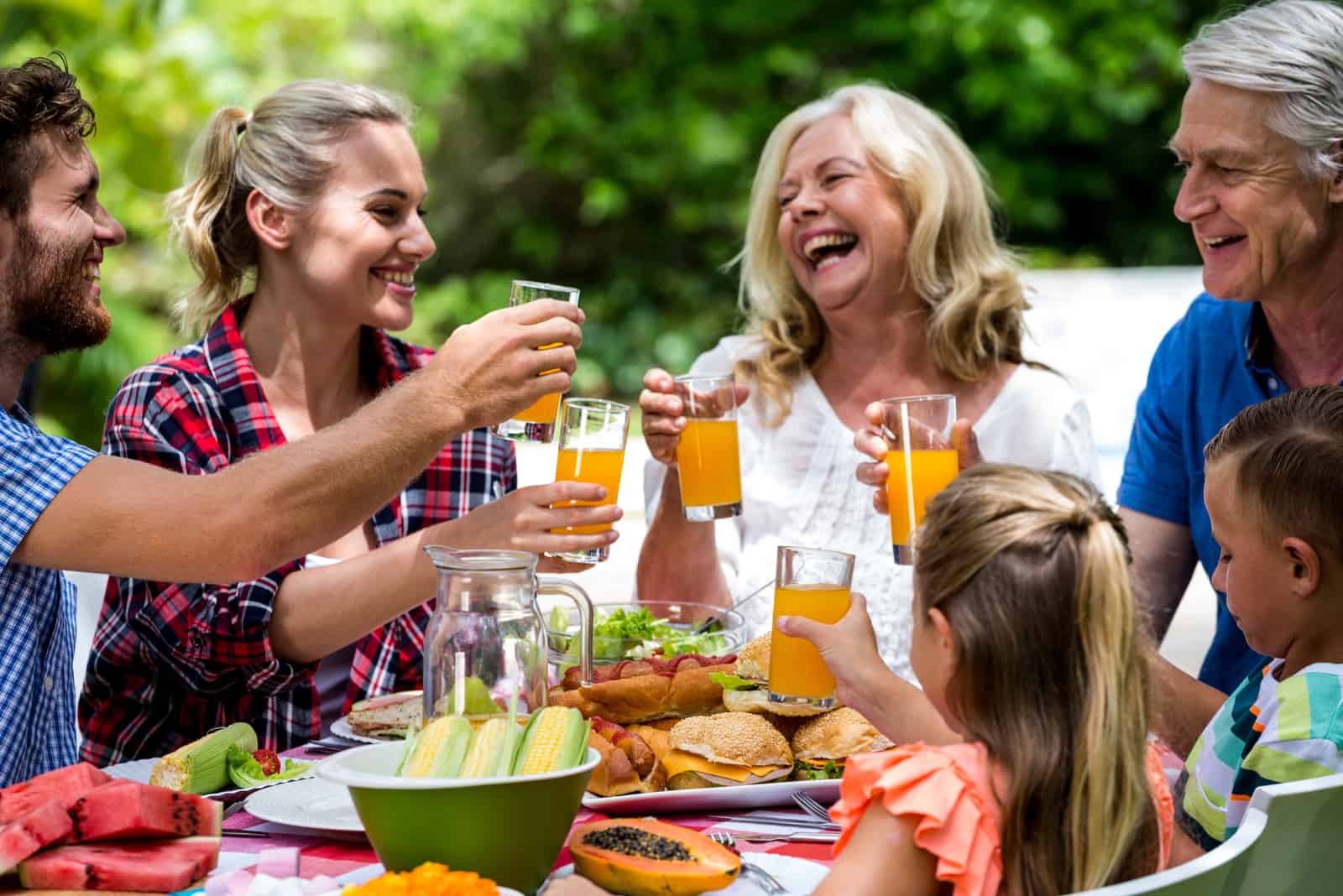 family toasting with orange juice on lunch time