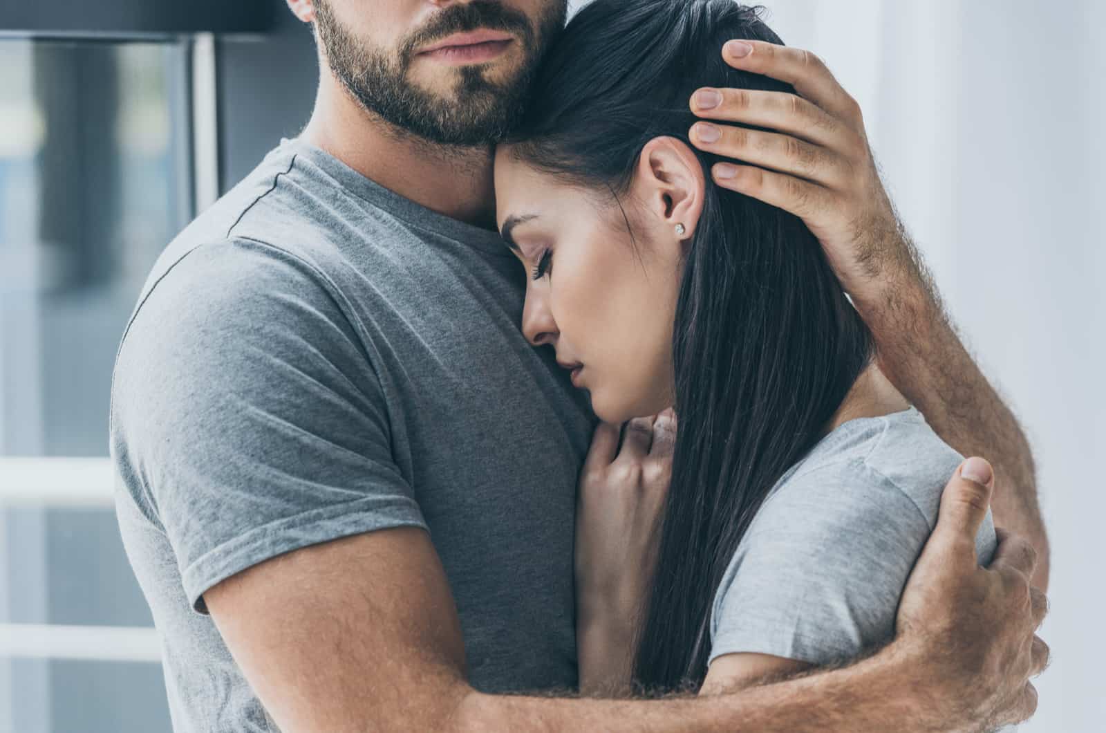 man comforts sad girlfriend