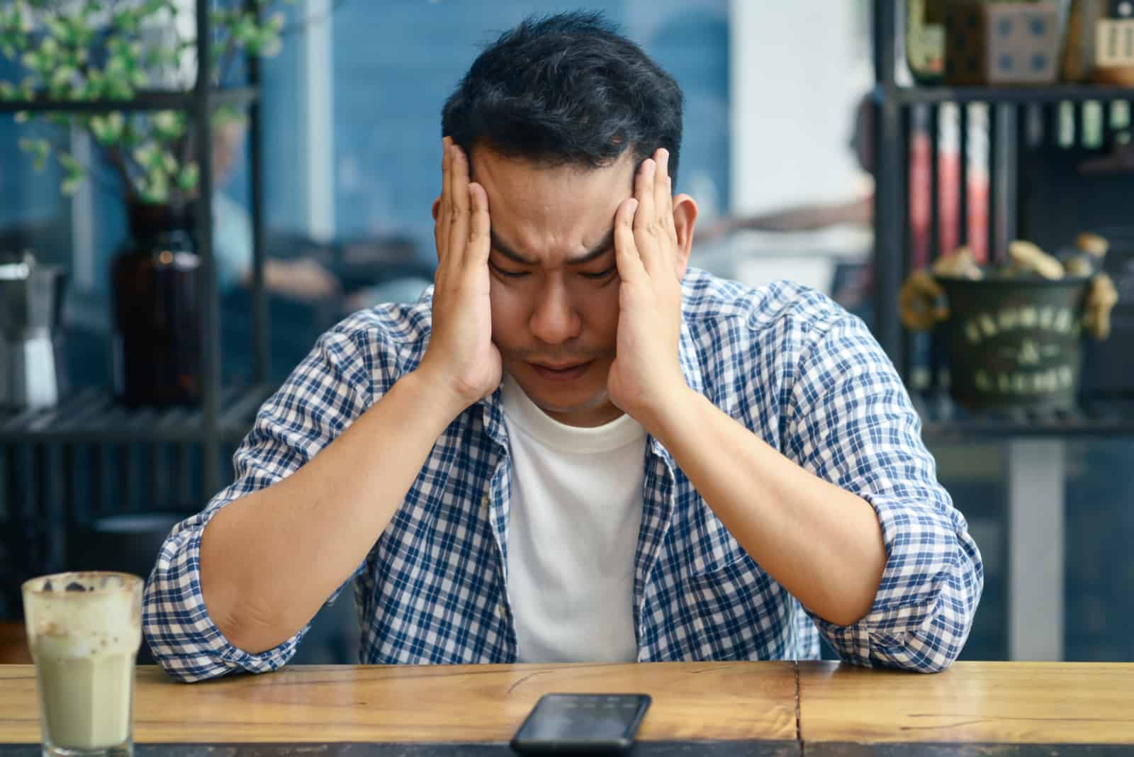 man crying in cafe