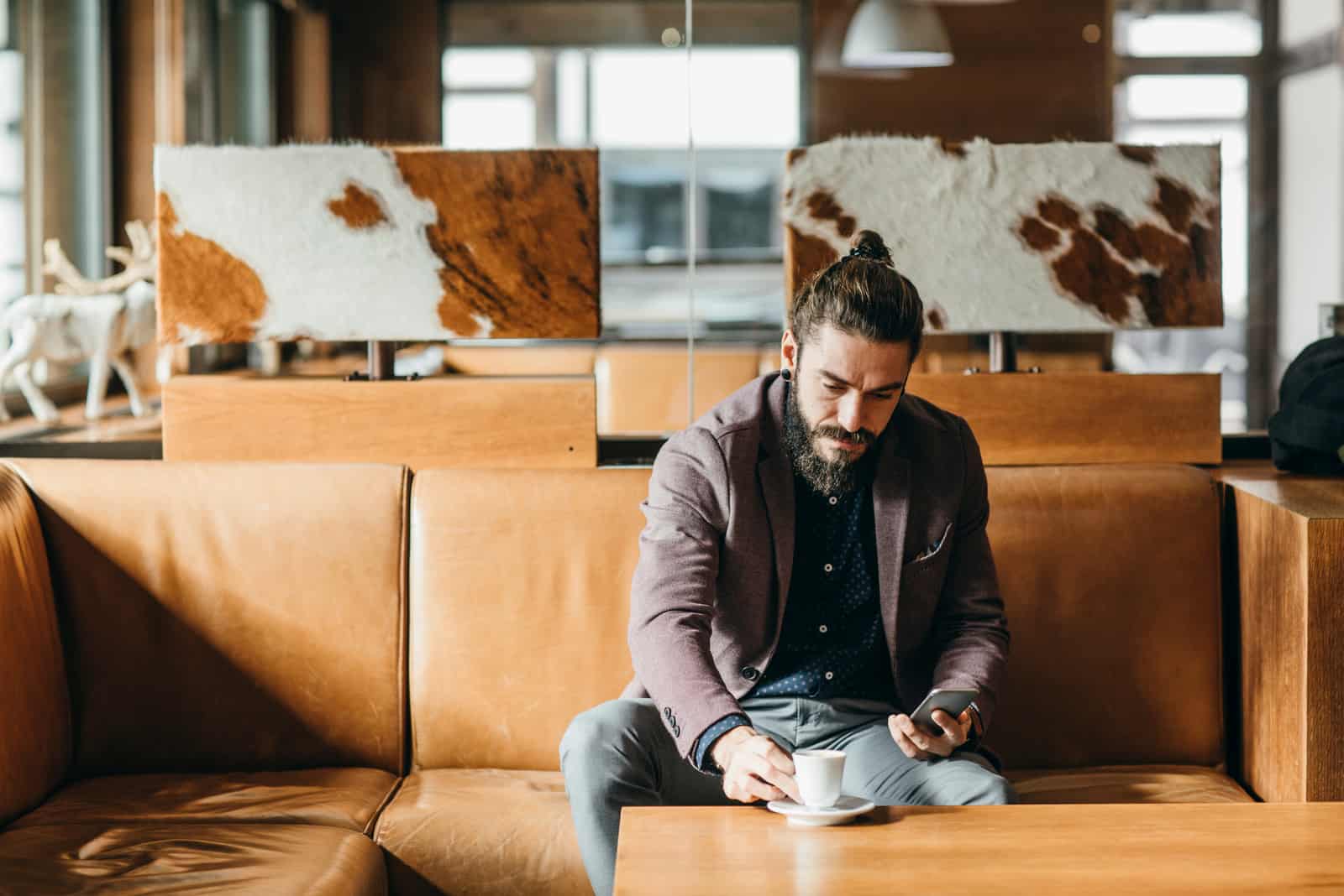 man sitting in cafe drinking coffee