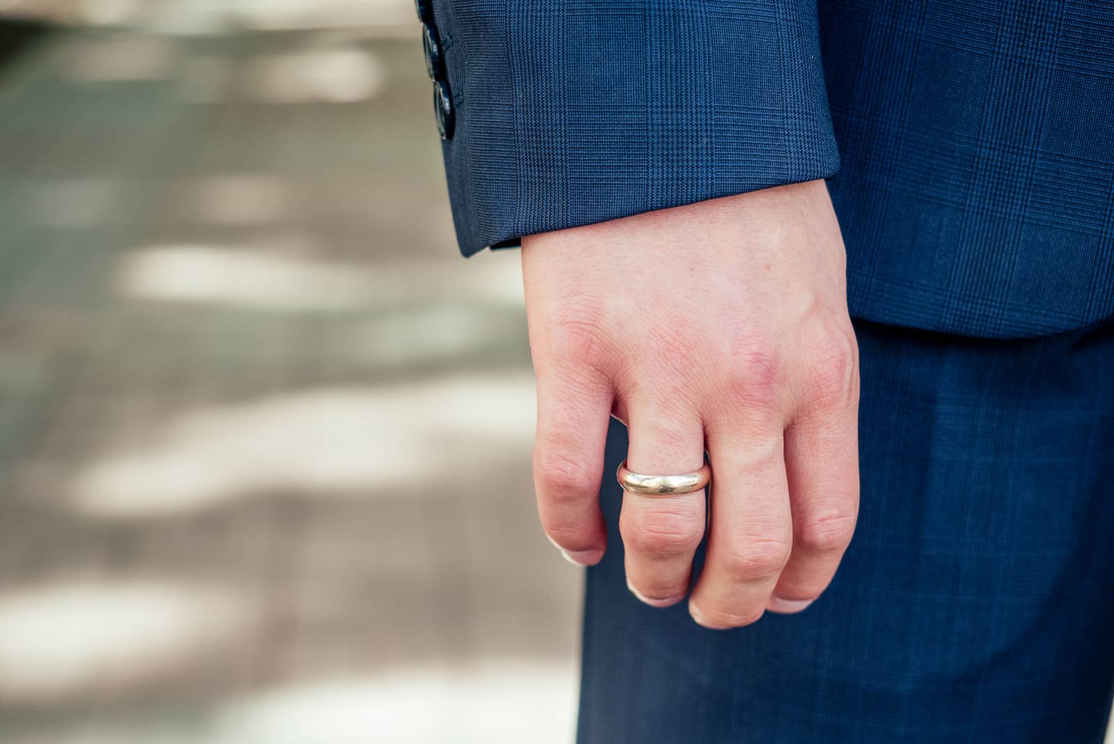 man wearing a wedding ring on his finger