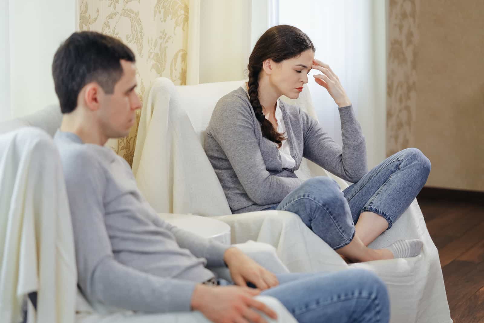 stressed couple sitting after big fight