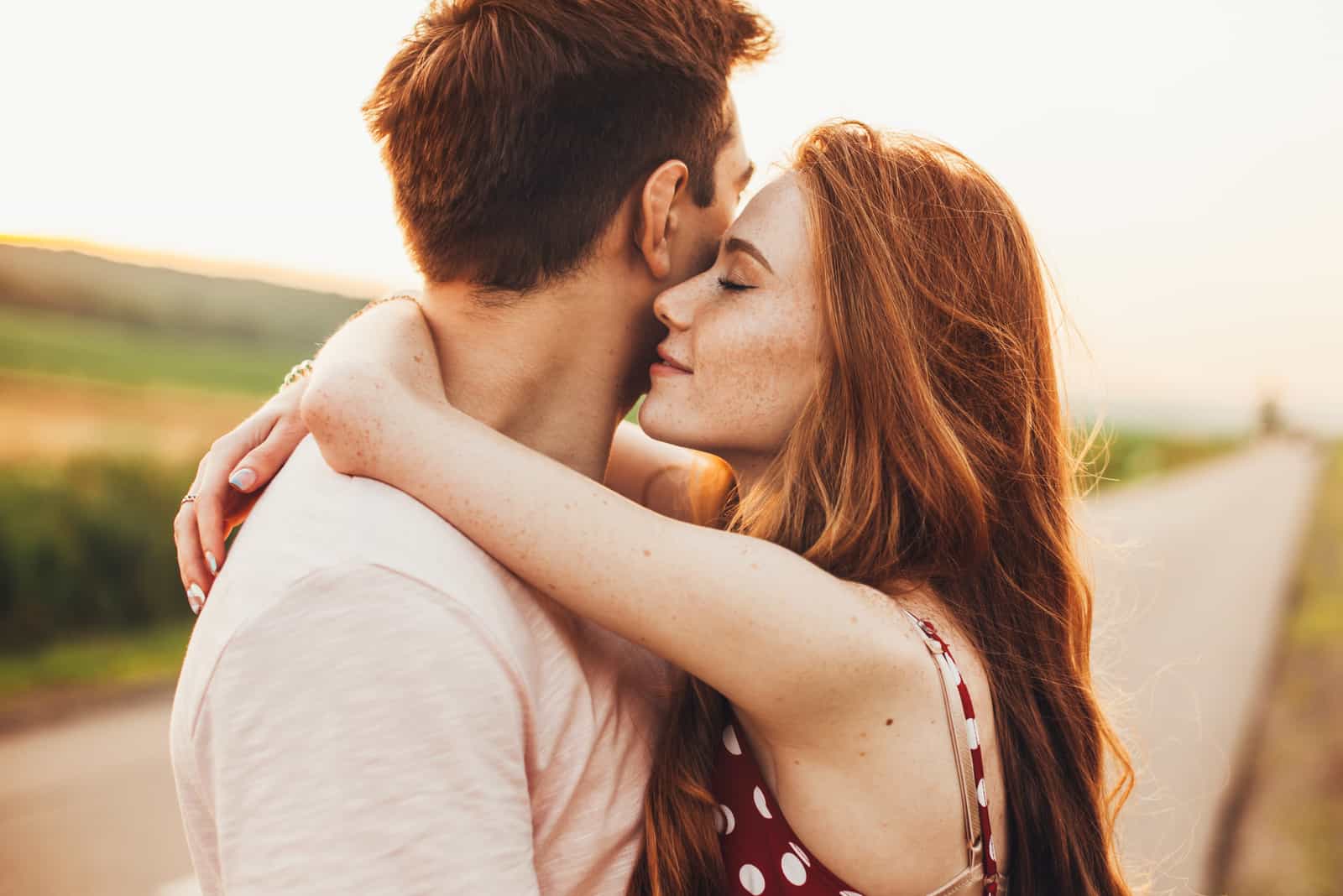 young couple hugging on the road