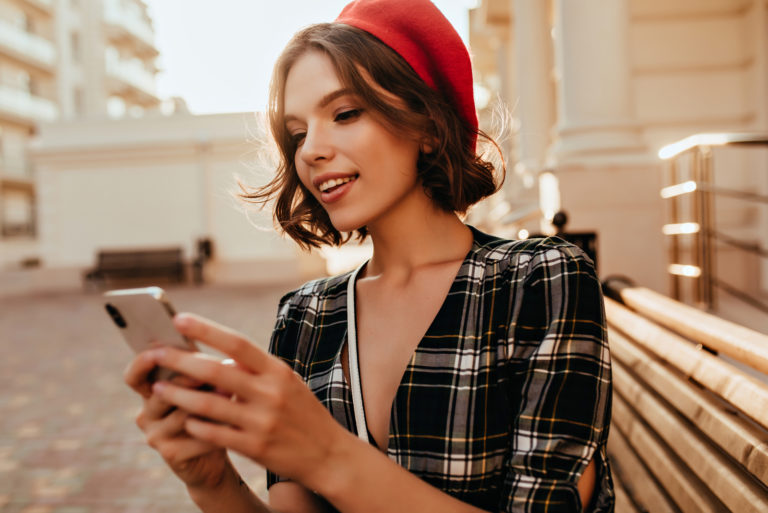 young woman texting on her phone