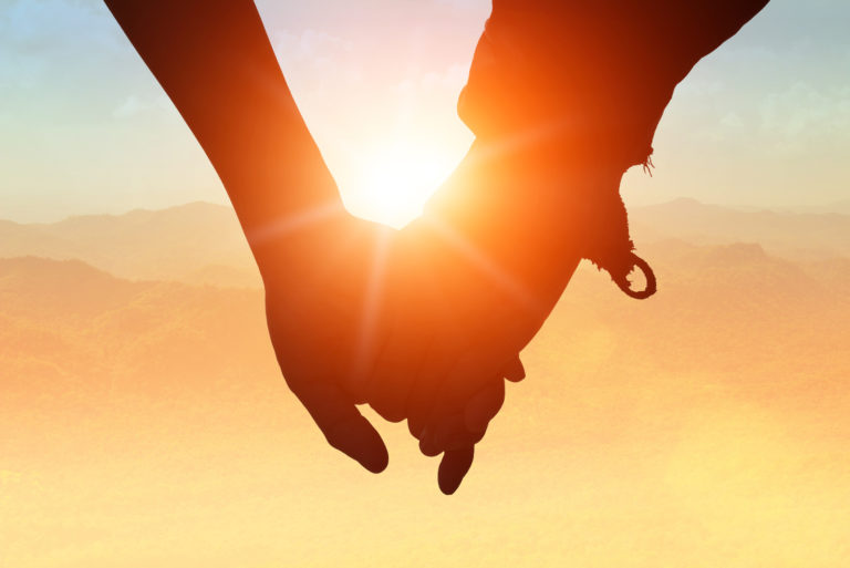 two people holding hands