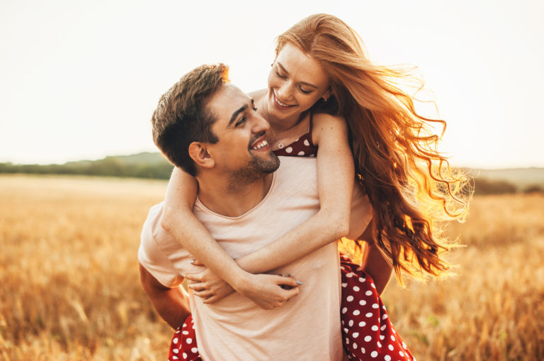 man carrying his girlfriend on back