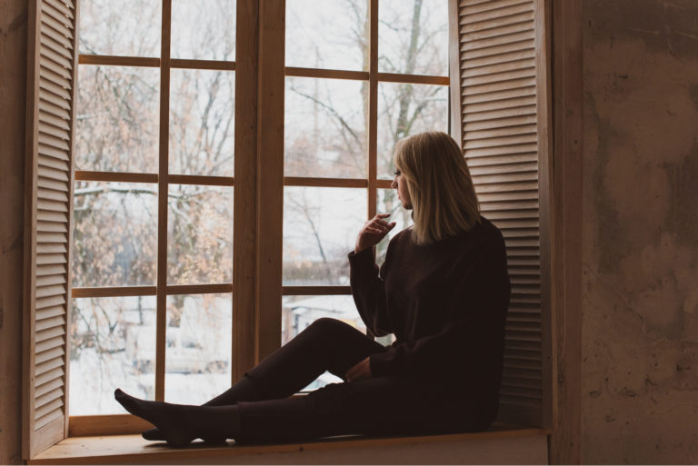 an imaginary woman sitting by the window