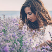 a beautiful woman standing in a lavender field
