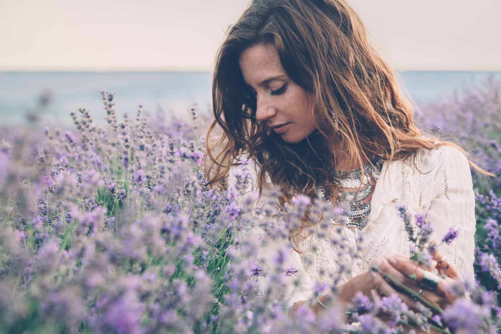 a beautiful woman standing in a lavender field