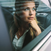 woman looking through car window