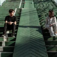 two people sitting at stairs