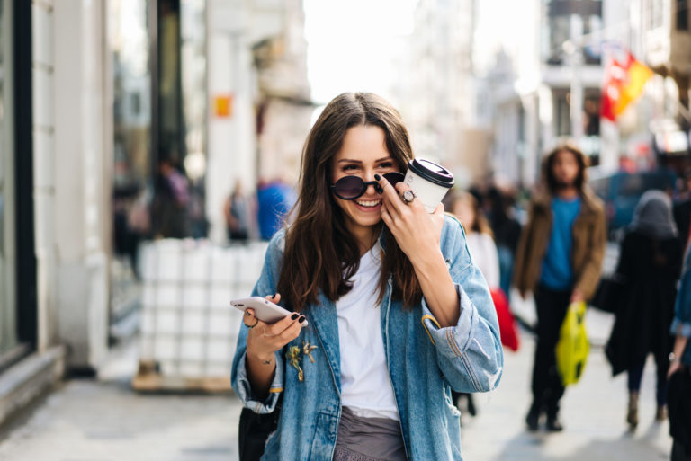happy woman walking on street