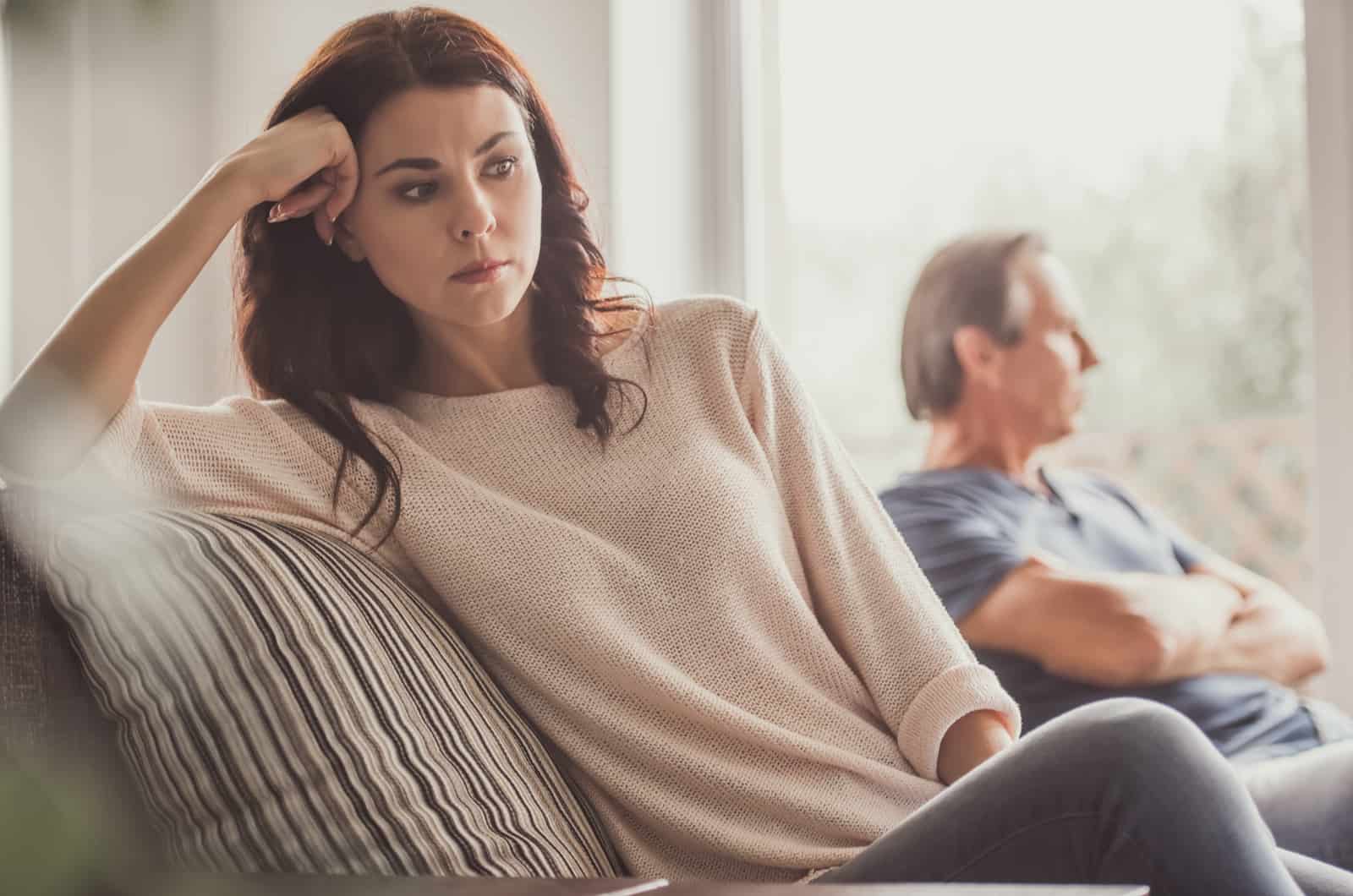 couple sitting on sofa after fight