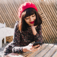 a smiling girl holding a phone in her hand