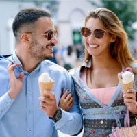 couple walking with ice cream in hand